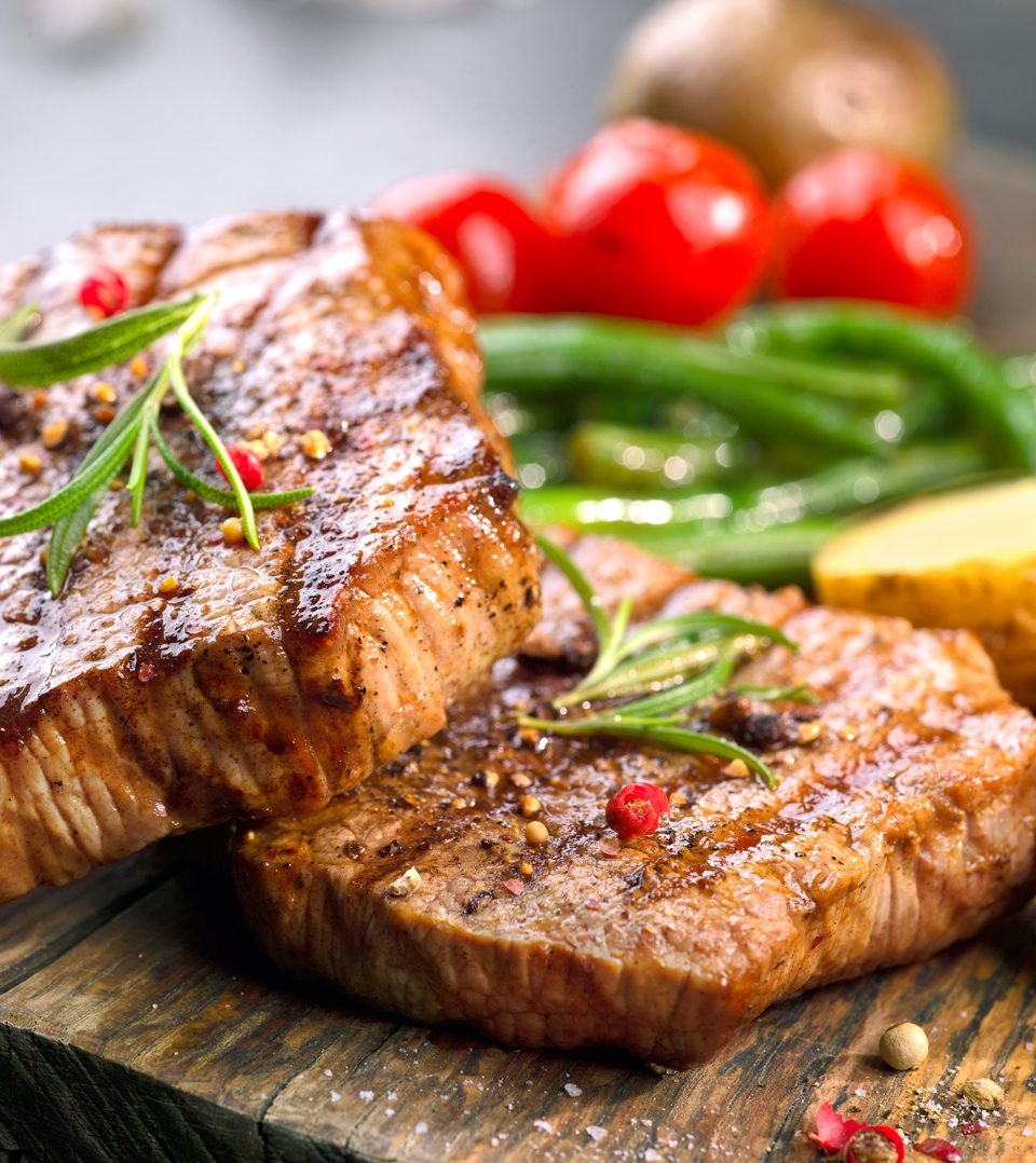 A close up of some meat on the grill